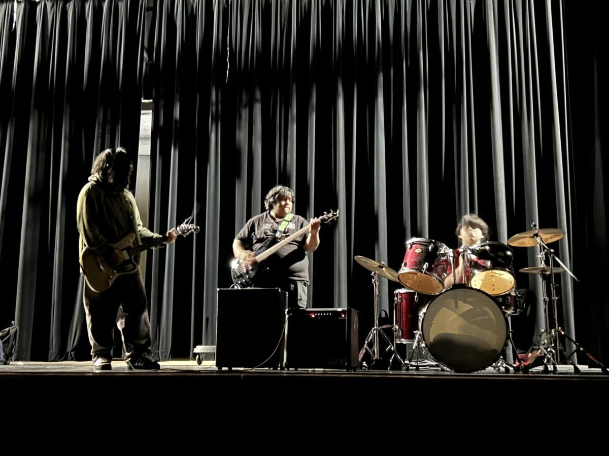 Kennedy students rehearsing in auditorium.