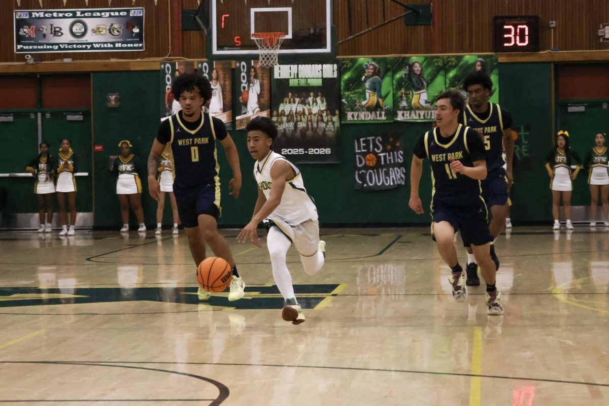 On February 11 in the Kennedy gym, Amari Rideaux is on a fast break to the rim being chased by 3 other West Park players. He finished the game with 5 points.