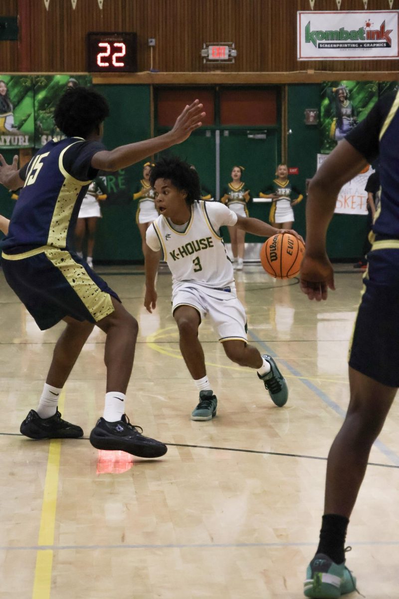 On February 11 in the Kennedy gym, Marcus Menefee is guarded trying to find a open player to pass the ball to. He finished the game will 21 points.