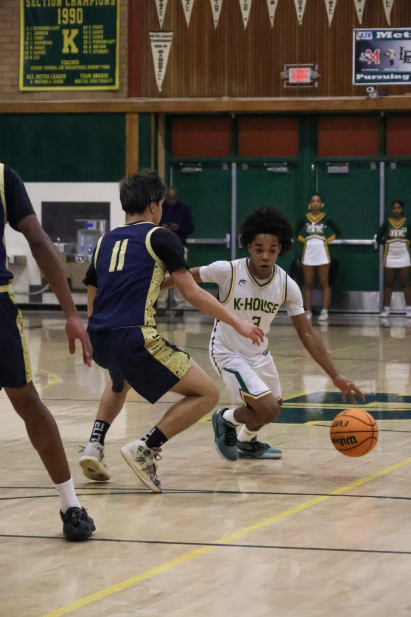 On Feburary 11 in the Kennedy gym, Marcus Menefee is guarded by a West Park player as Marcus drives into the paint to try and score a shot.