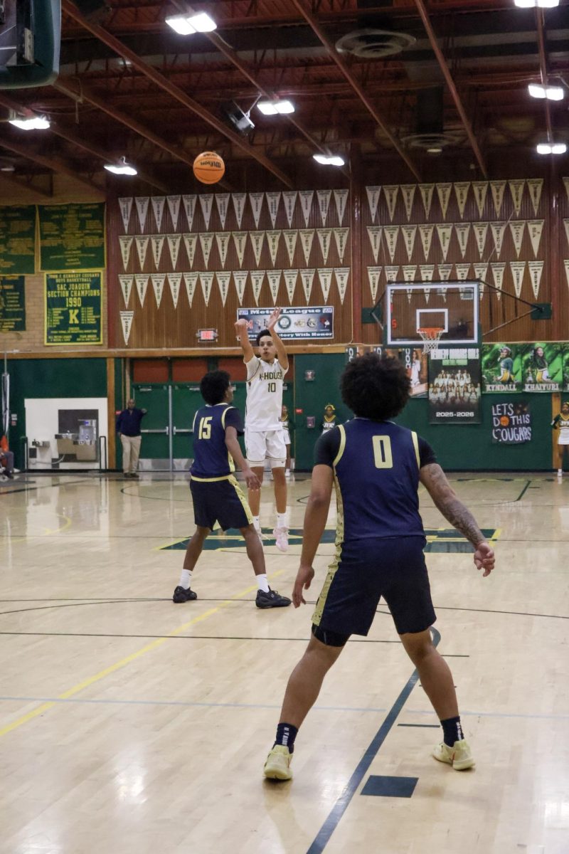On Feburary 11 in the Kennedy gym, Ciel Nixon is taking a three point shot. He then made the three pointer.