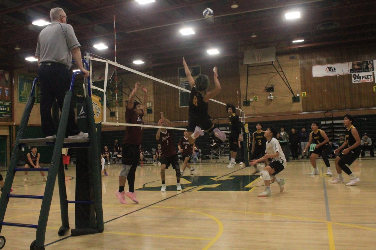 Senior Hiram Garcia (#8) rises above the net for a powerful spike on Tuesday Feb 24. Garcia played a key role in the Cougar’s competitive 3-1 victory. 