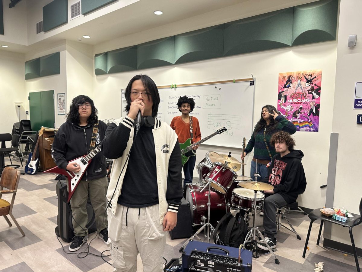 Jan 7, Shoal members, Seniors Daniel Hoyos, Jeremiah Thao, Isaiah Mercado, Sahara Niazi Sharma, and Elijah Aguirre, in the band practice room getting ready to practice for their performance.