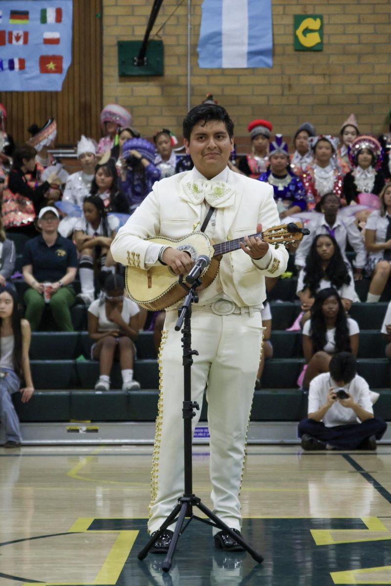 Lionel De Leon performs a song at the Multicultural rally on Friday March 20. This performances was along with a violinist by the name of Michael Dincuta.