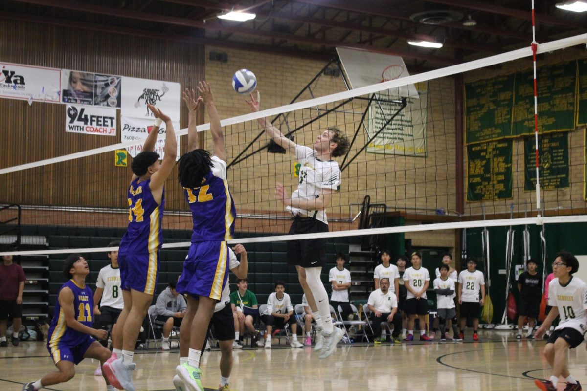 Alexander Francois (#11) leaps to tip the ball over the net on Tuesday March 24. This helped keep the rally going for Kennedy.