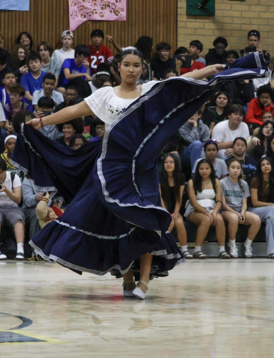 A dancer from Brown Issues Club performing at the Multicultural rally on Friday March 20 at the Kennedy Gym. This was the folklorico dance, a tradition originating from Mexico.
