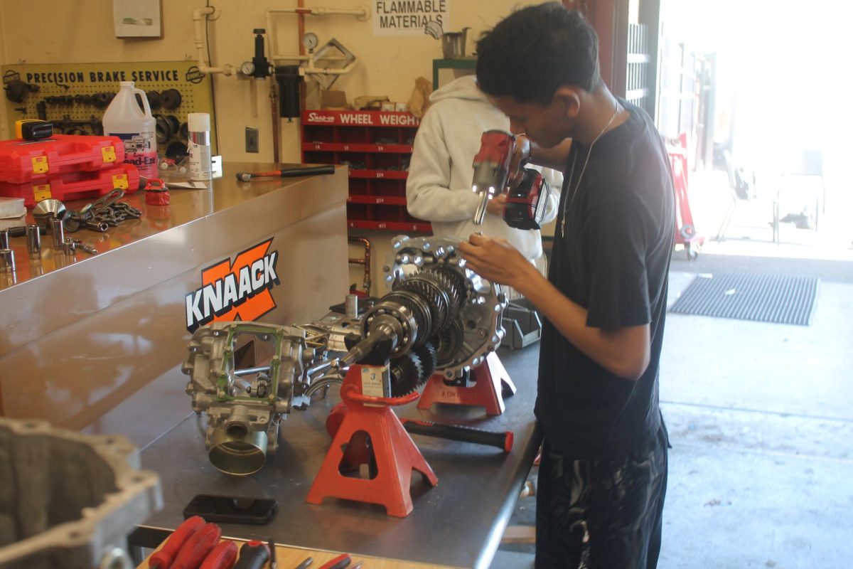 Angel Reyes Barajas starts repairing an engine on March 2. This engine was to be put in the car for it to run.