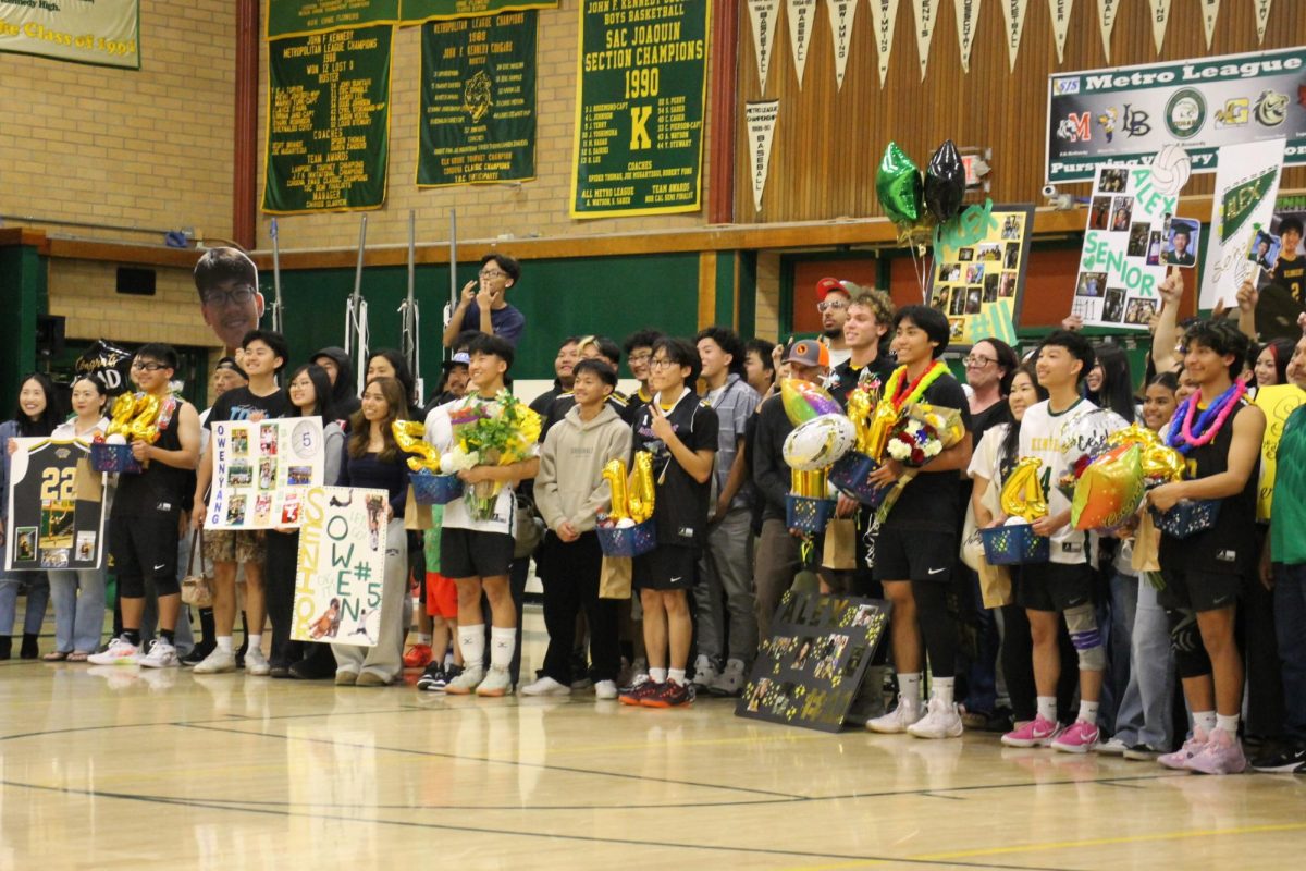 Caption: Kennedy’s Seniors line up together on Senior Night, smiling proudly with their families on Thursday April 16. The moment captures their final home game together and the bond they have for each other.